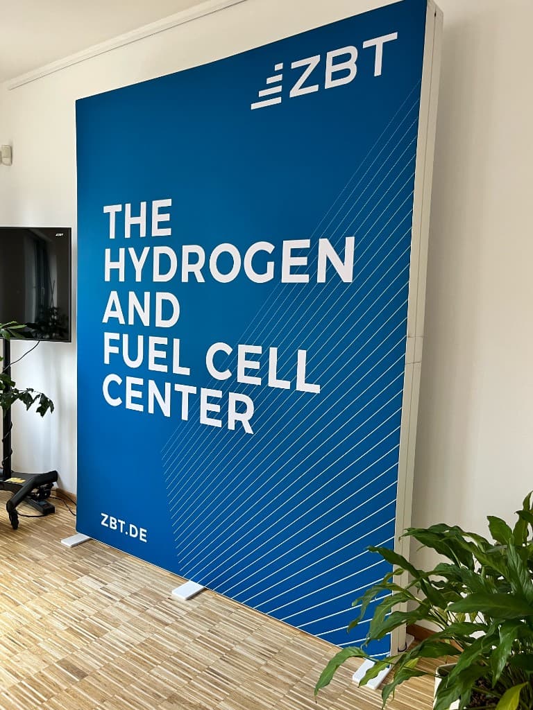 Banner del ZBT — The Hydrogen and Fuel Cell Center, centro de I+D en pilas de combustible e hidrógeno, Duisburg, Alemania, durante la gira AgenciaSE